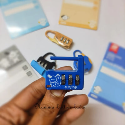 Blue combination lock held by a hand with blurred cards in the background