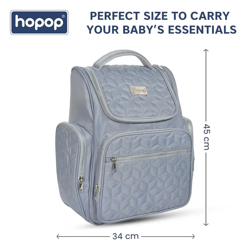 Front view of a black geometric quilted pattern diaper backpack with silver zippers and a subtle brand tag. www.usmile.toys 
