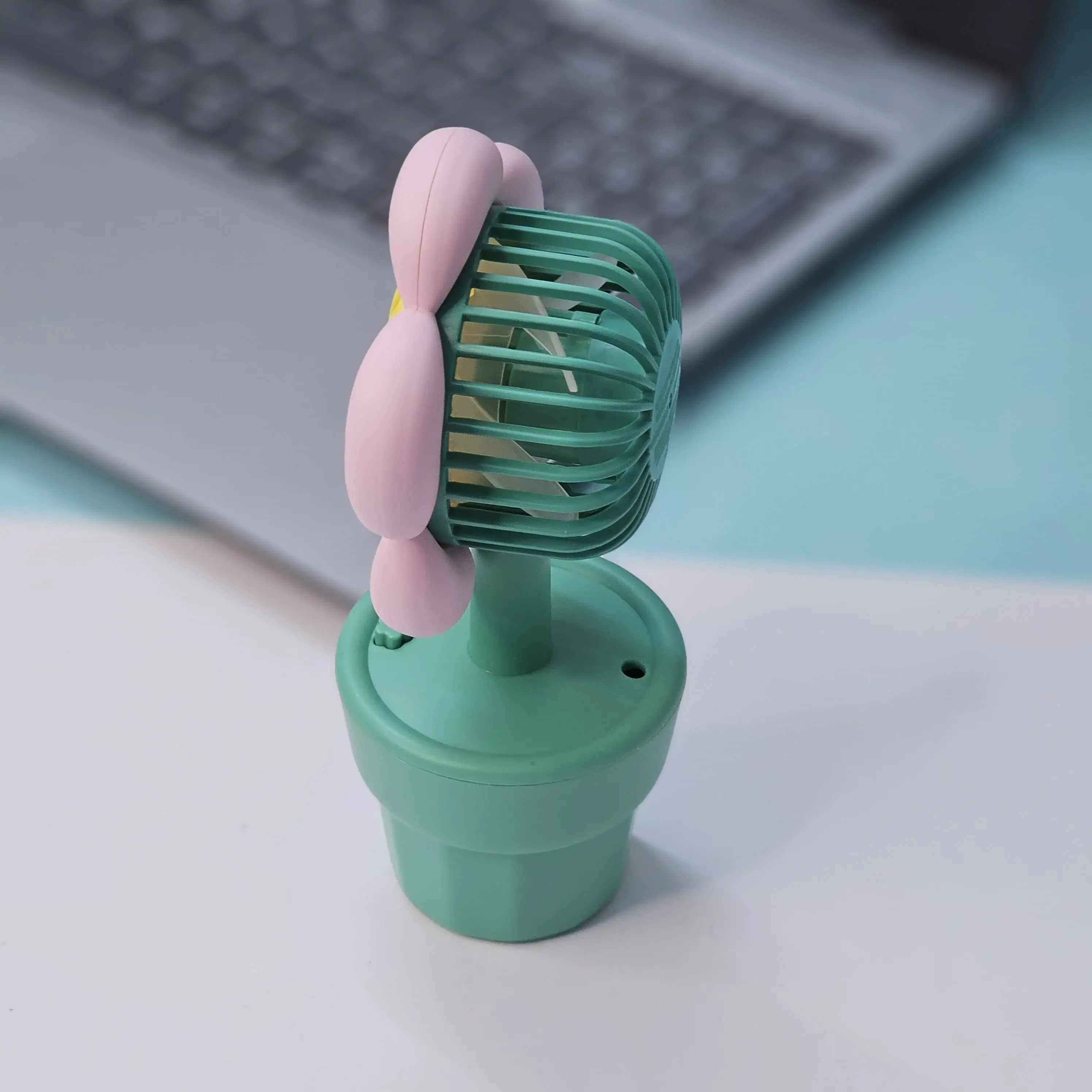 Set of three Usmile Toys flower-shaped mini desk fans in yellow, purple, and pink, each in a green pot with 'smile' text, perfect for kids' rooms or desks."