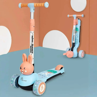Children's scooter with rabbit design on a blue surface against an orange wall.