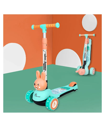 Children's scooter with bunny design on a green surface against an orange wall.