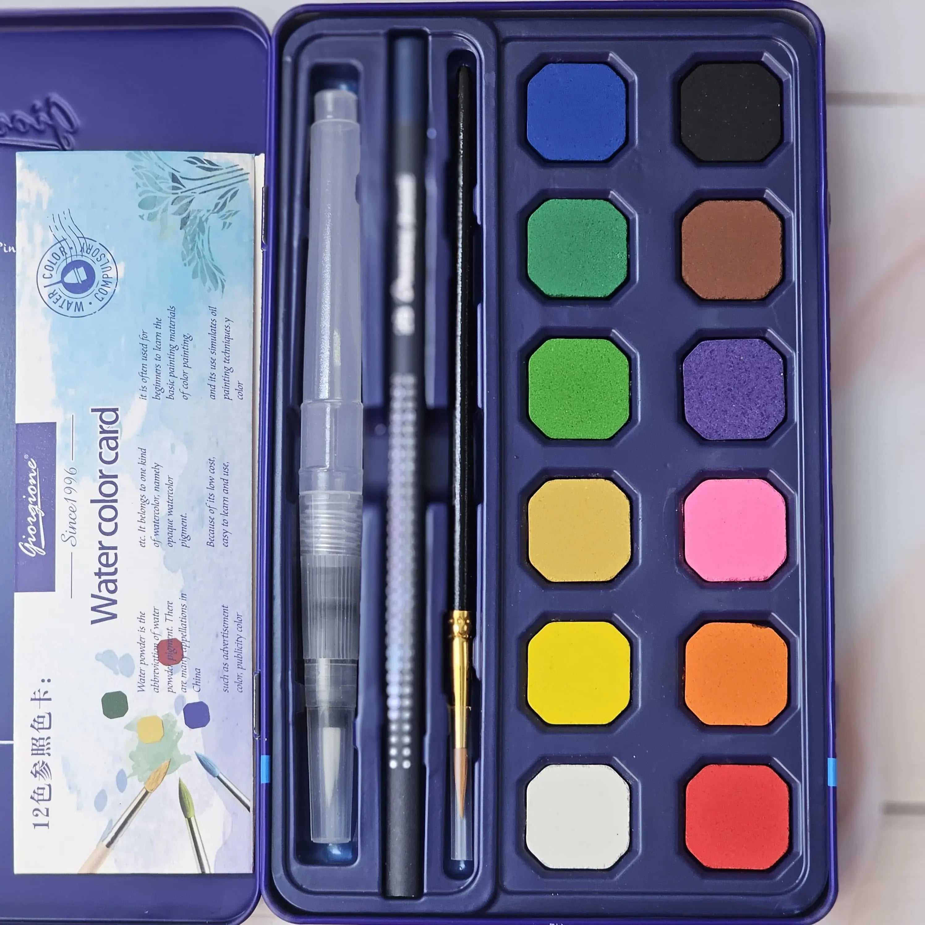 Dark blue box for a 12-color Giorgione Watercolor Cakes set by Usmile Toys, including an absorbent sponge and water brush, an ideal art kit for children." www.usmile.toys