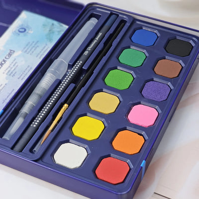 Usmile Toys art supplies: a 'Compulsory Course' 12-color solid watercolor cake set, complete with water brush and sponge, as shown on its packaging." www.usmile.toys