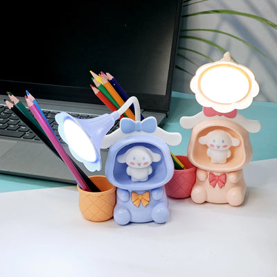 Set of three Usmile Toys Astronaut Teddy Lamps in blue, pink, and green, each featuring a glowing flower-shaped light and a base designed as a convenient pencil holder." www.usmile.toys