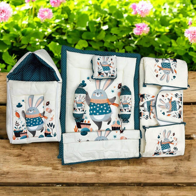 7 in 1 newborn baby bedding combo set in light green with cute elephant and leaf prints. Includes a baby sleeping bag, mattress, two bolsters, pillow, and two zip-up blankets, perfect for comfortable and safe infant sleep. Ideal for baby shower gifts and nursery decor. www.usmile.com