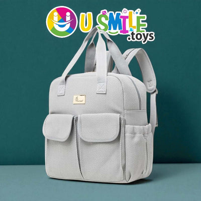 Gray backpack with a visible brand logo on a teal background