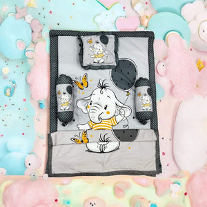 Green 7 in 1 newborn baby bedding set with elephant print, including sleeping bag, mattress, bolsters, pillow, and blankets. www.usmile.com
