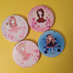 Four round compact mirrors with cartoon character designs on a yellow background