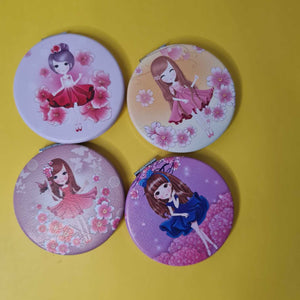 Four round mirrors with cartoon character designs on a yellow background