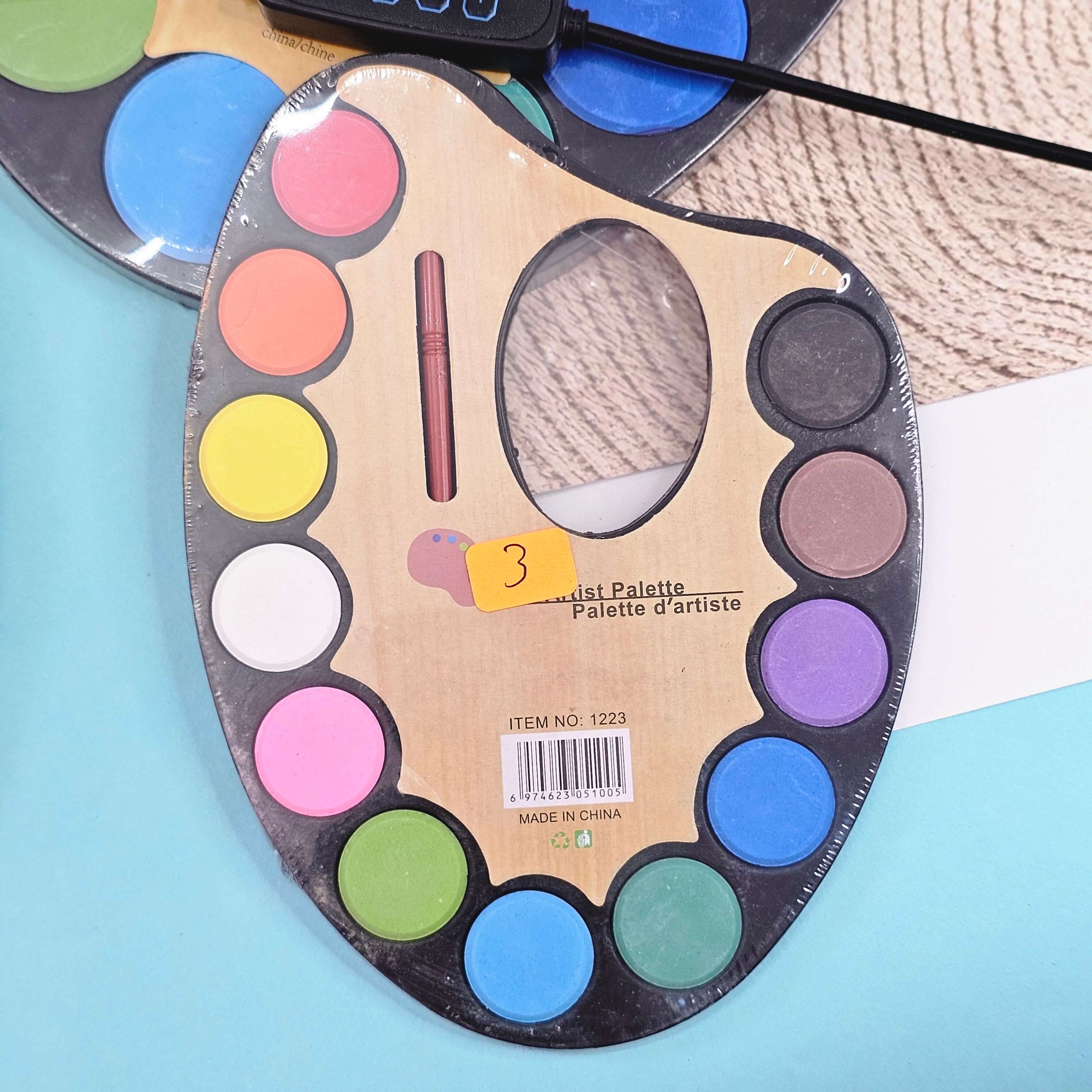 Creative art supplies: A compact watercolor paint set labeled "Artist Palette," featuring a variety of hues for children to explore painting, a great addition to any art collection, available at Usmile Toys. www.usmile.toys