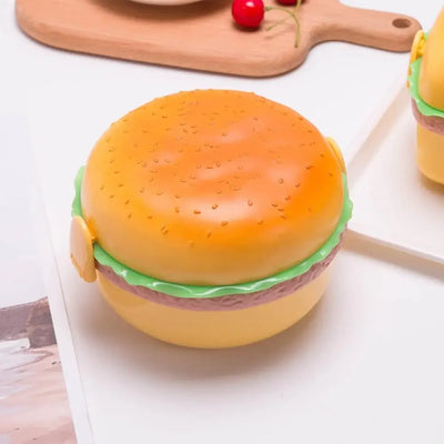 Round burger-shaped plastic tiffin box for kids, ideal for school lunch. www.usmile.toys