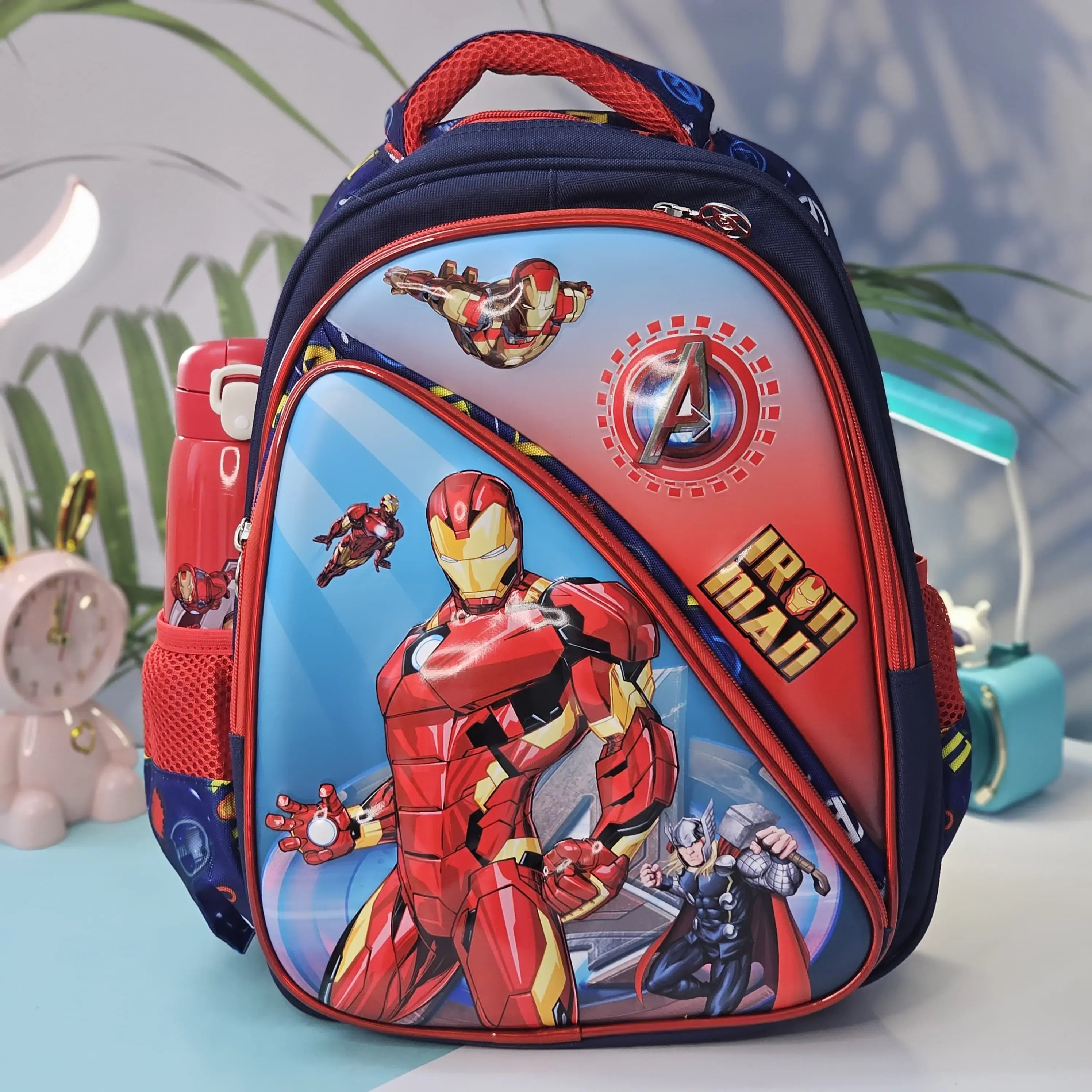 Vibrant blue children's backpack featuring large Iron Man and Thor graphics, with a red trim and side mesh pocket, perfect for kids by Usmile Toys." www.usmile.toys