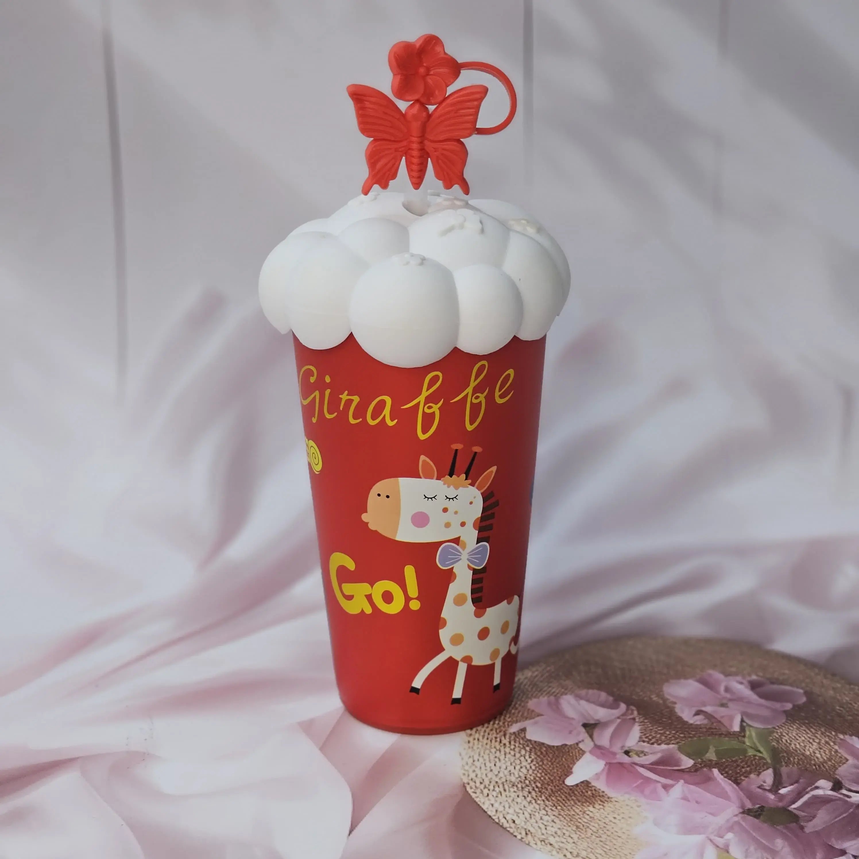 Front view of five Usmile Toys kids' insulated cups, each with a different cartoon design (pug, donut, bunny, giraffe, girl) and a distinctive cloud-like lid with a matching character straw topper." www.usmile.toys