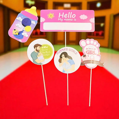Set of baby-themed name tags on sticks with illustrations and text.