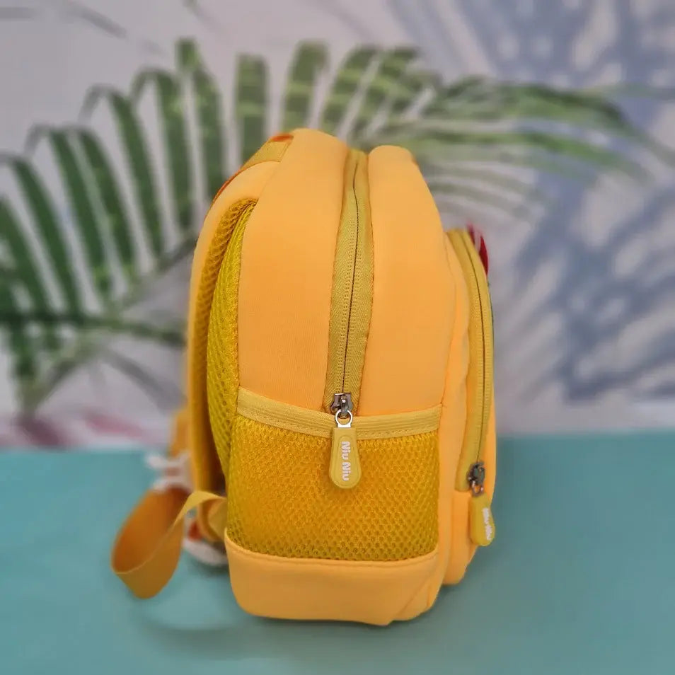 Small, yellow backpack for children featuring a large green dinosaur applique with red spikes and white teeth on the front pocket. Above the dinosaur is embroidered yellow cursive text that reads "My Funny Dino". The backpack has yellow straps and yellow mesh side pockets