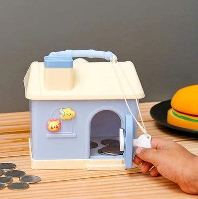 Kids' house money bank with lock, key, and 3D sticker compatibility, in pastel pink and blue.www.usmile.toys
