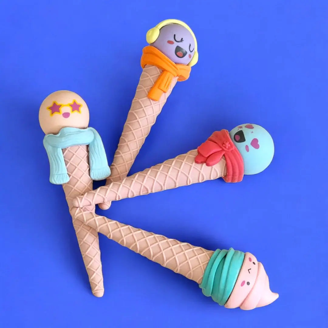 Set of three adorable ice cream cone shaped erasers for kids, featuring colorful 'scoops' with cute faces and tiny scarves. Perfect stationery for school from uSmile.toys." www.usmile. toys