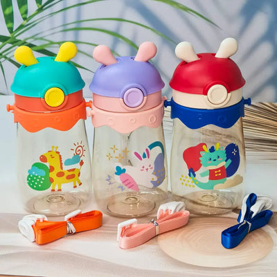 Set of three colorful kids water bottles with cute animal prints, featuring bunny, giraffe, and dragon designs. Each bottle includes a playful lid with 3D cartoon ears and comes with a matching strap for easy carrying. These BPA-free, leak-proof bottles are ideal for school, travel, and outdoor use—perfect addition to kids stationery and daily essentials
