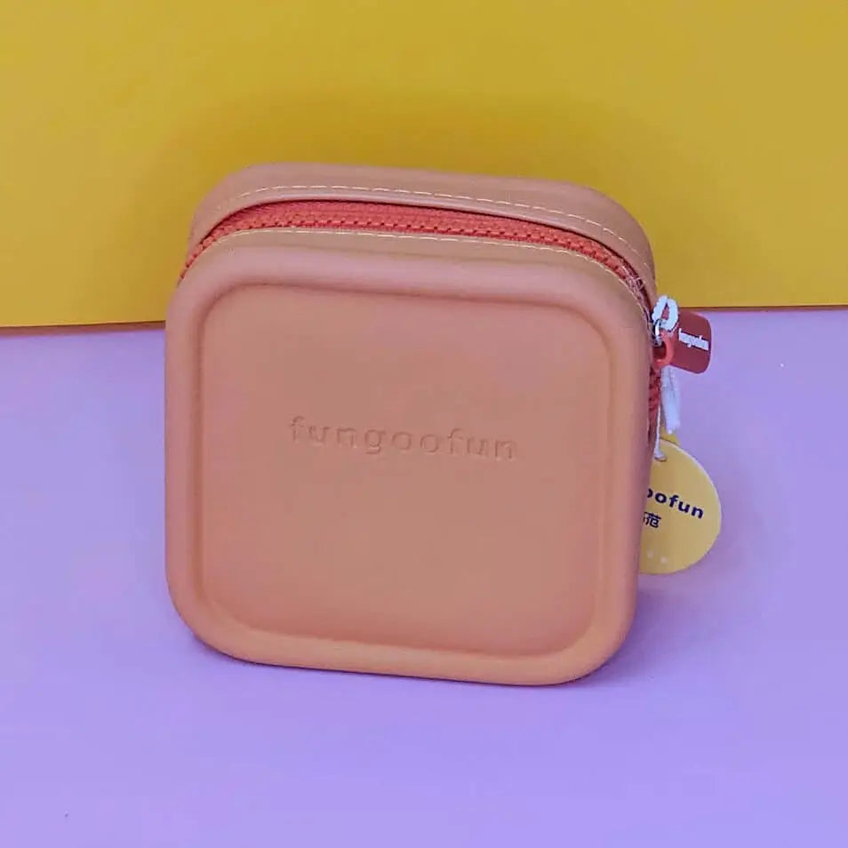 Pink square pouch with zipper on a purple and yellow background