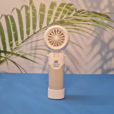 Colorful collection of portable bladeless mini fans for kids in pastel pink, green, blue with bear ears, and cream, designed with a child-safe bladeless head and single-button operation. These rechargeable USB fans are ideal for travel, school desks, or bedtime comfort, offering quiet and efficient cooling in a cute, compact design. Perfect return gift or utility item for children, available at U Smile Toys online store