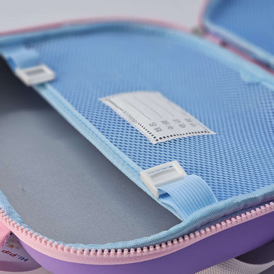 Close-up of a blue and pink pencil case with a label inside.