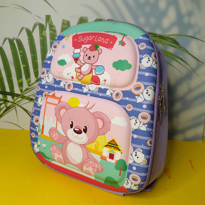 Children's backpack with teddy bear design on a yellow surface