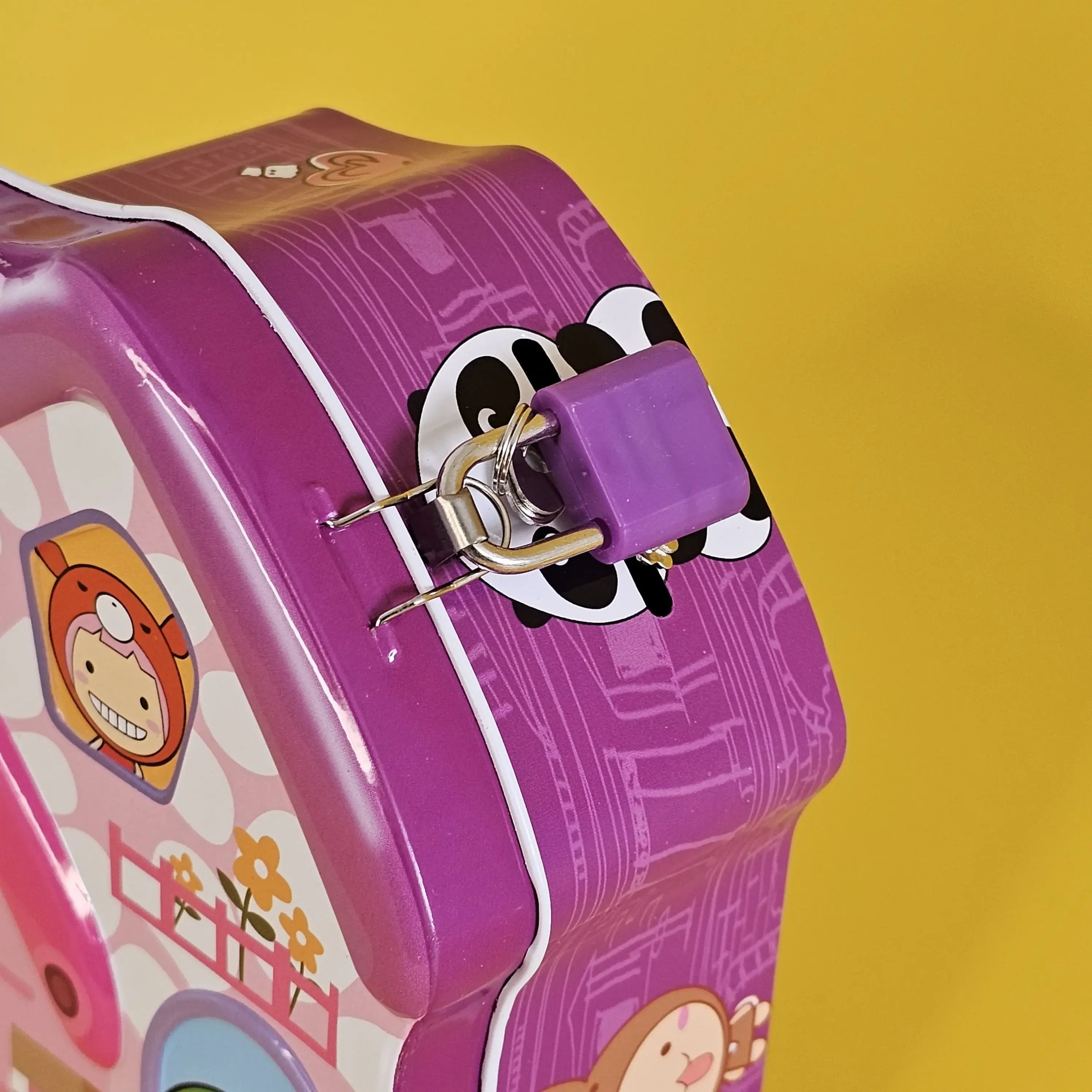 Kids' metal coin banks with locks, house shaped, in green, purple, and blue. www.usmile.toys