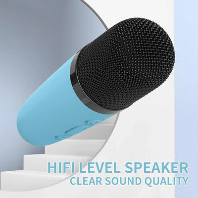 Usmile Toys children's karaoke set: a compact, light blue portable speaker featuring a fun dinosaur graphic and an orange handle, accompanied by a wireless microphone." www.usmile.toys