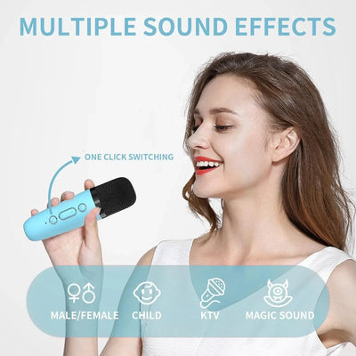 Usmile Toys children's karaoke set: a compact, light blue portable speaker featuring a fun dinosaur graphic and an orange handle, accompanied by a wireless microphone." www.usmile.toys
