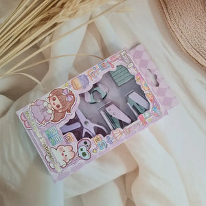 Adorable 9-piece Kawaii mini stationery gift set in pastel purple theme, perfect for school kids and return gift ideas – includes stapler, staple remover, hole puncher, tape holder with tape roll, sharpener, scissor, and a box of staples. Packaged in a beautifully designed cartoon-themed gift box with cute illustrations and soft pink-purple tones. Ideal for girls aged 5 and above who love fun and functional stationery items – available at U Smile Toys India