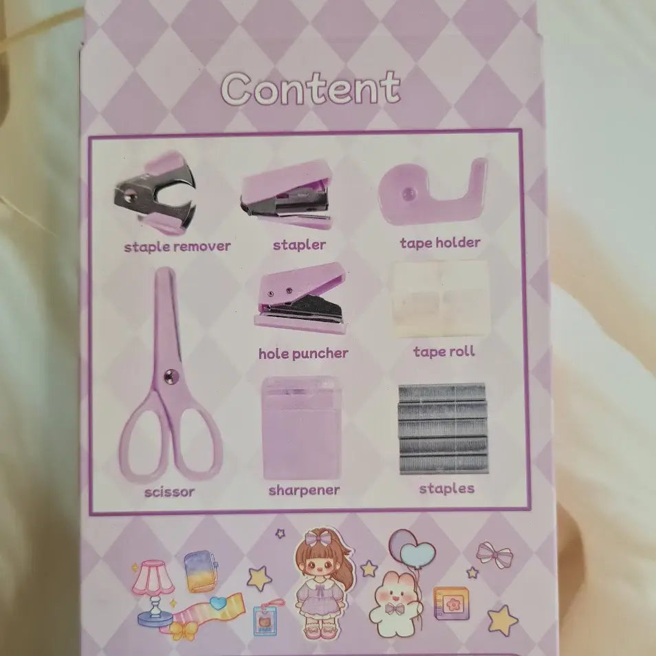 Adorable 9-piece Kawaii mini stationery gift set in pastel purple theme, perfect for school kids and return gift ideas – includes stapler, staple remover, hole puncher, tape holder with tape roll, sharpener, scissor, and a box of staples. Packaged in a beautifully designed cartoon-themed gift box with cute illustrations and soft pink-purple tones. Ideal for girls aged 5 and above who love fun and functional stationery items – available at U Smile Toys India