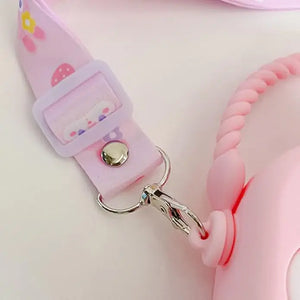 "Front view of a Usmile Toys girls' crossbody purse, made of purple silicone in a charming bunny shape, displayed among tropical leaves." www.usmile.toys