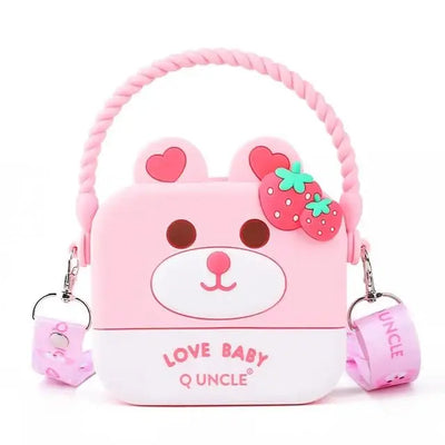 "Front view of a Usmile Toys girls' crossbody purse, made of purple silicone in a charming bunny shape, displayed among tropical leaves."
