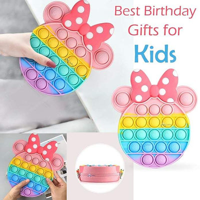Front view of a Usmile Toys girls' sling bag, designed as a rainbow Pop It fidget toy with a prominent pink Minnie Mouse-style bow and a striped strap." www.usmile.toys