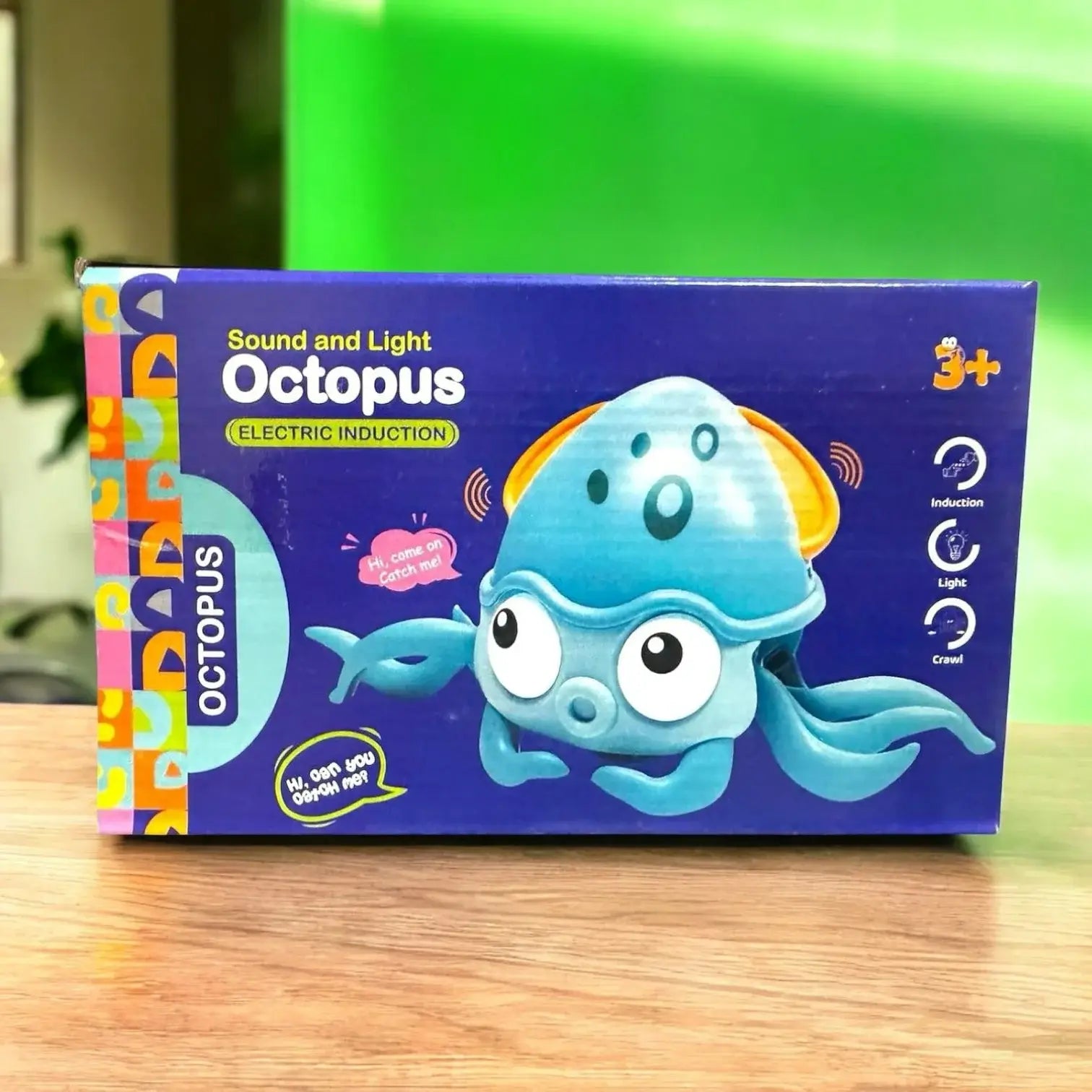 "Blue box for a Usmile Toys Sound and Light Octopus electric induction toy, featuring a cute blue octopus with a light-up head and phrases like 'Hi, come on! Catch me!'" www.usmile.toys