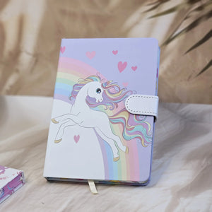 Four colorful pocket-sized diaries with unicorn illustrations, including a light blue diary that reads 'TIME TO BE A UNICORN', each with a clasp lock www.usmile.toys