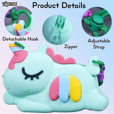 Close-up of a light blue unicorn-shaped silicone cross-body purse with rainbow stripe detail, matching unicorn comb, keychain, and circular mirror. Ideal stylish bag for girls from uSmile.toys." www.usmile,.toys